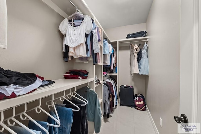 walk in closet with tile patterned floors