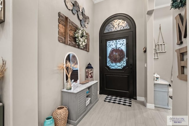 entrance foyer featuring ornamental molding