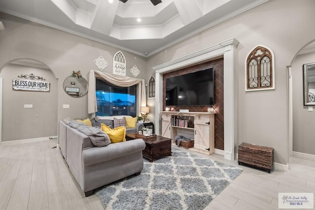 living room featuring ceiling fan, ornamental molding, and light hardwood / wood-style floors