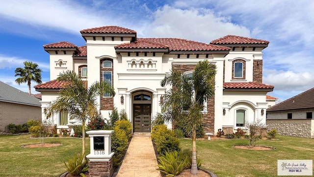 mediterranean / spanish-style house featuring a front yard