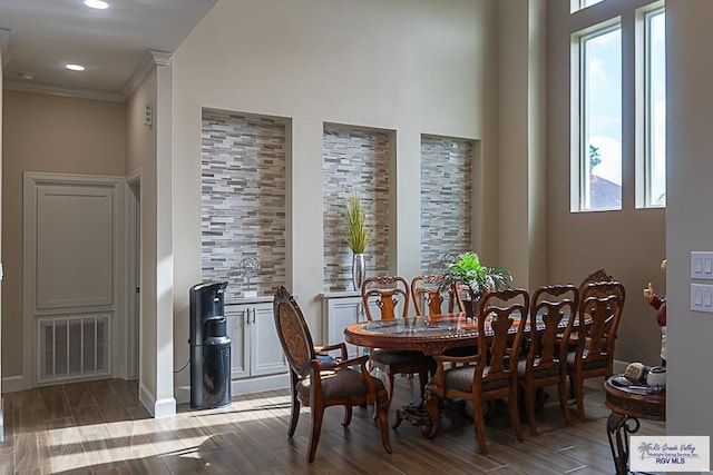 dining space featuring crown molding