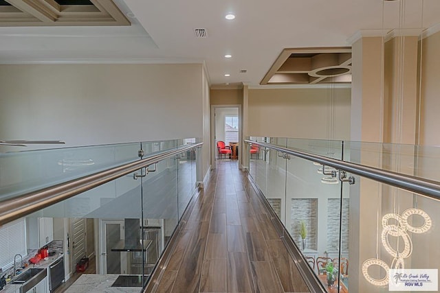 hall with ornamental molding, sink, and dark hardwood / wood-style flooring