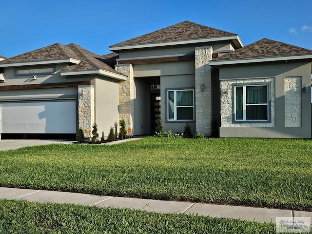 view of front of home with a garage and a front lawn