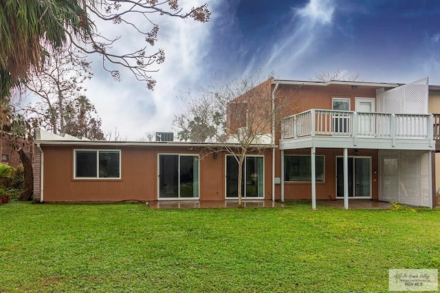 rear view of property featuring a wooden deck, a yard, and central AC unit