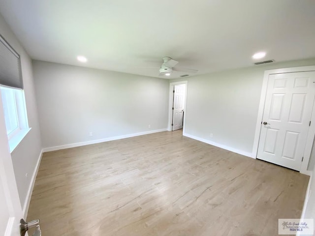 empty room featuring a ceiling fan, baseboards, recessed lighting, and light wood-style flooring