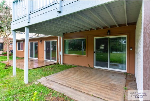 back of property with a wooden deck