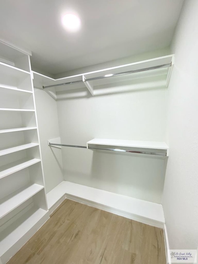 spacious closet with wood finished floors