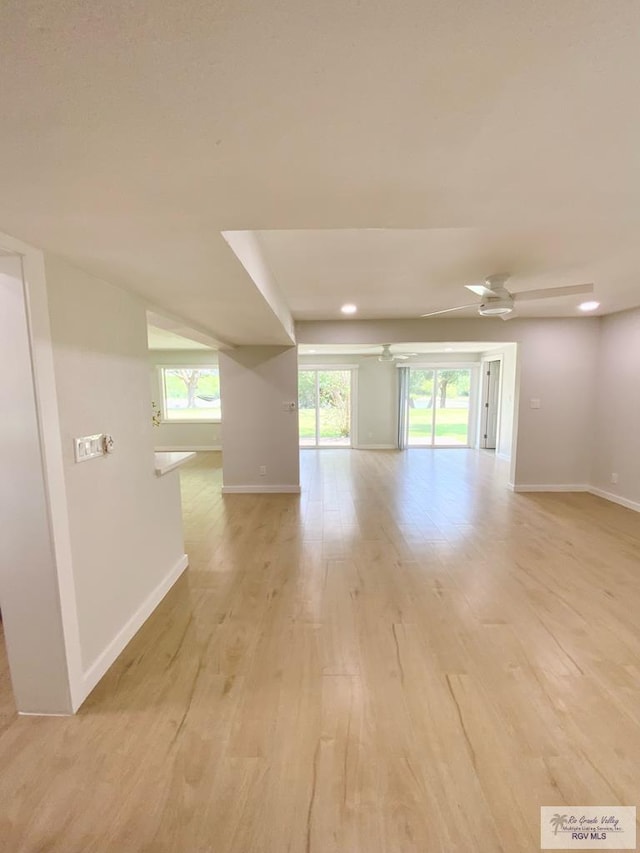 spare room with light wood-style floors, baseboards, ceiling fan, and recessed lighting