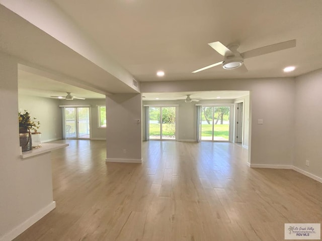 interior space featuring recessed lighting, ceiling fan, baseboards, and light wood finished floors