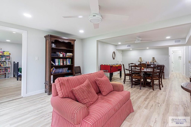 living room with ceiling fan and light hardwood / wood-style floors