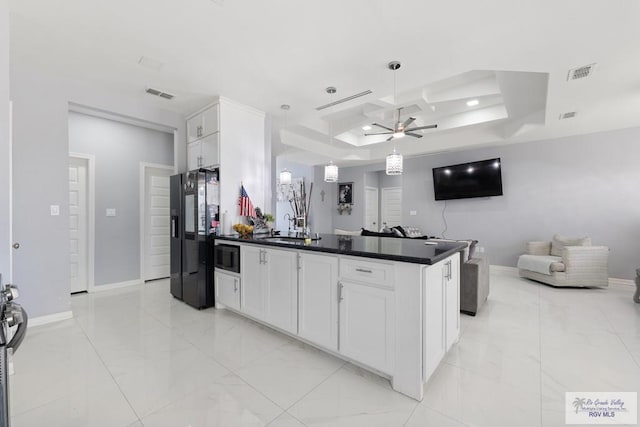 9129 Lake Charles Dr, Los Fresnos, TX 78566 - kitchen featuring black appliances, a tray ceiling, dark countertops, ceiling fan, and open floor plan