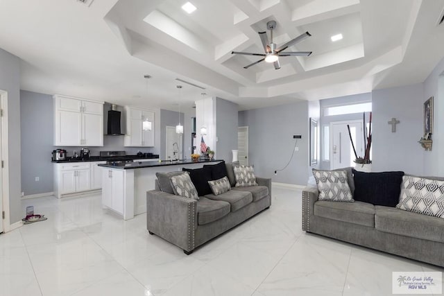 9129 Lake Charles Dr, Los Fresnos, TX 78566 - living room with a ceiling fan, a tray ceiling, coffered ceiling, and light marble finish flooring