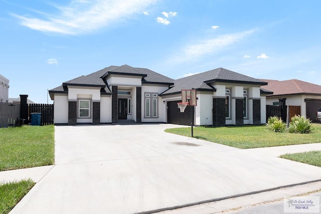 9129 Lake Charles Dr, Los Fresnos, TX 78566 - prairie-style house featuring an attached garage, concrete driveway, and stucco siding