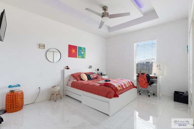 9129 Lake Charles Dr, Los Fresnos, TX 78566 - bedroom with light marble finish floors, a tray ceiling, and ceiling fan