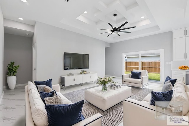 living room with coffered ceiling and ceiling fan