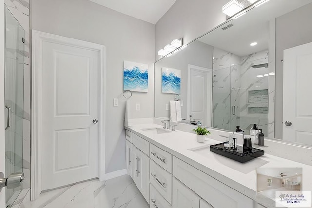 bathroom with vanity and a shower with door