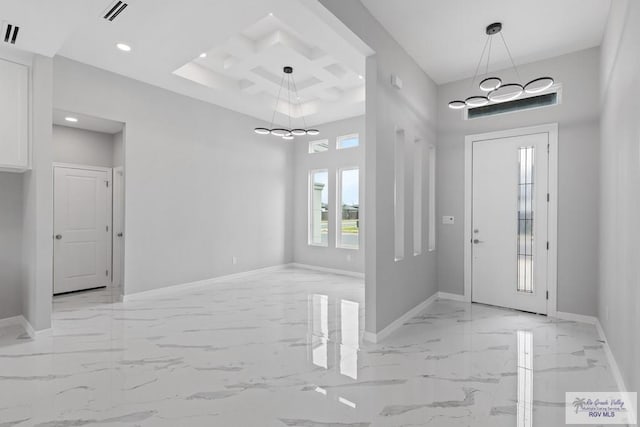 foyer with coffered ceiling, a towering ceiling, and a chandelier