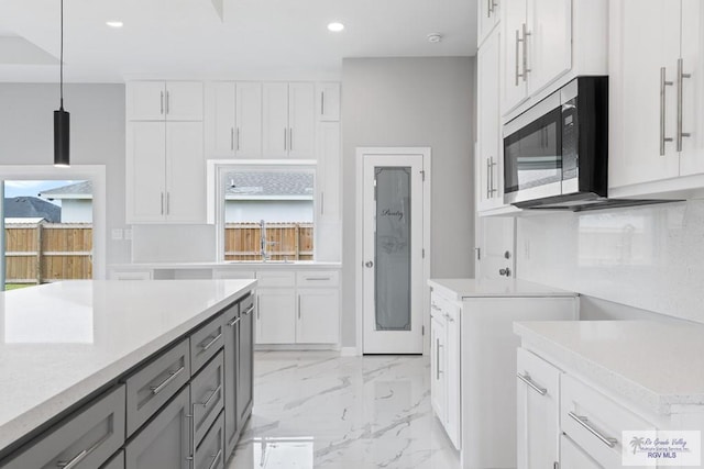 kitchen with white cabinetry, pendant lighting, and gray cabinets