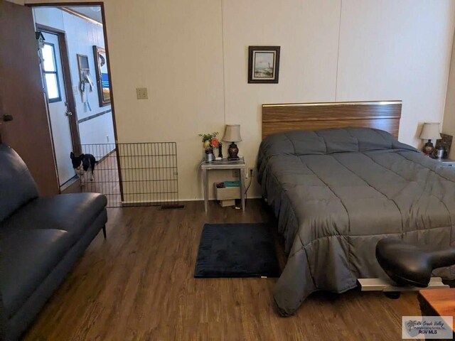 bedroom with hardwood / wood-style floors