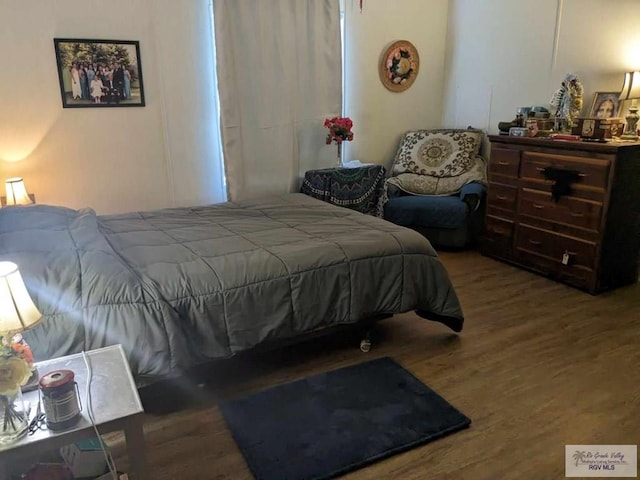 bedroom with hardwood / wood-style flooring