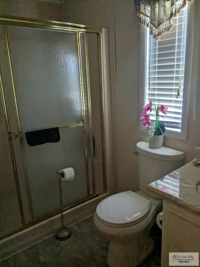 bathroom featuring vanity, toilet, and walk in shower