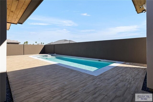 view of swimming pool featuring a deck