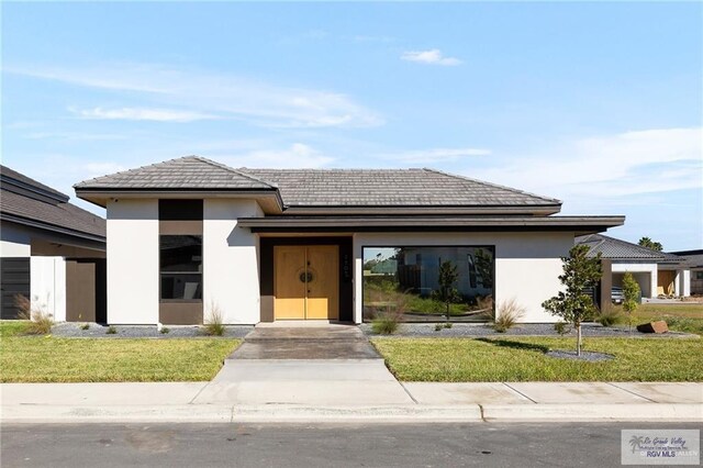 prairie-style house with a front lawn