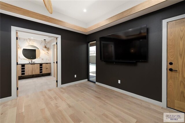 interior space with beam ceiling and light wood-type flooring