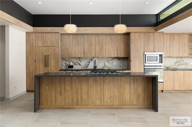 kitchen featuring decorative backsplash, stainless steel appliances, and hanging light fixtures