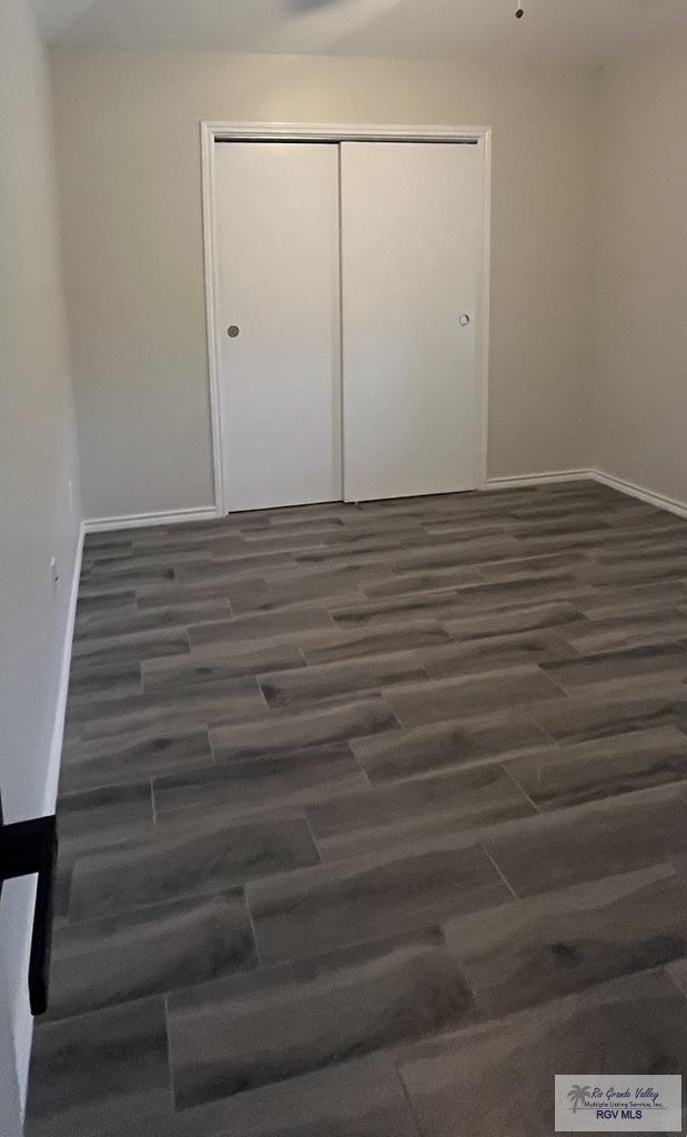 spare room with dark wood-type flooring