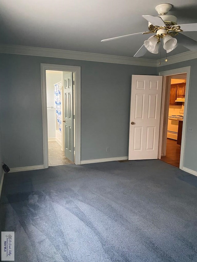 unfurnished bedroom featuring crown molding, baseboards, and carpet floors