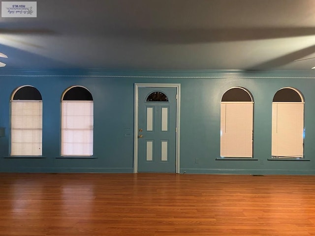 interior space featuring crown molding and wood finished floors