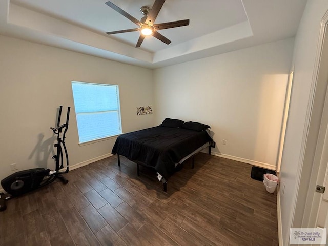 bedroom featuring ceiling fan and a raised ceiling