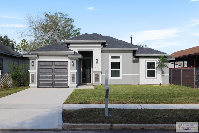 prairie-style house featuring a garage and a front yard