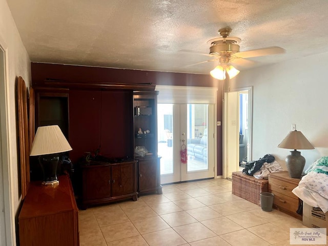 501 W Palm Valley Dr, Harlingen, TX 78552 - entryway featuring french doors, ceiling fan, light tile patterned flooring, and a textured ceiling