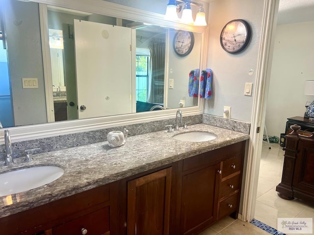 501 W Palm Valley Dr, Harlingen, TX 78552 - bathroom with tile patterned floors, a sink, and double vanity