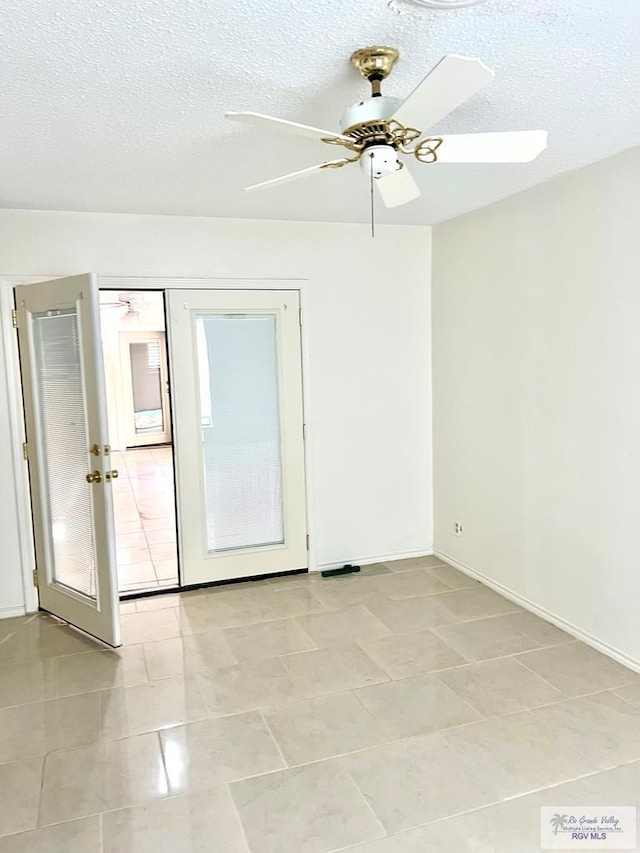 501 W Palm Valley Dr, Harlingen, TX 78552 - empty room with a textured ceiling, a ceiling fan, light tile patterned floors, and baseboards