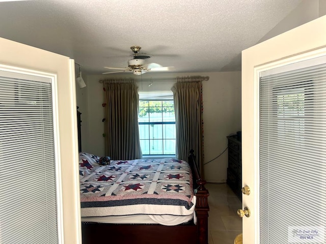 501 W Palm Valley Dr, Harlingen, TX 78552 - tiled bedroom with a textured ceiling and a ceiling fan