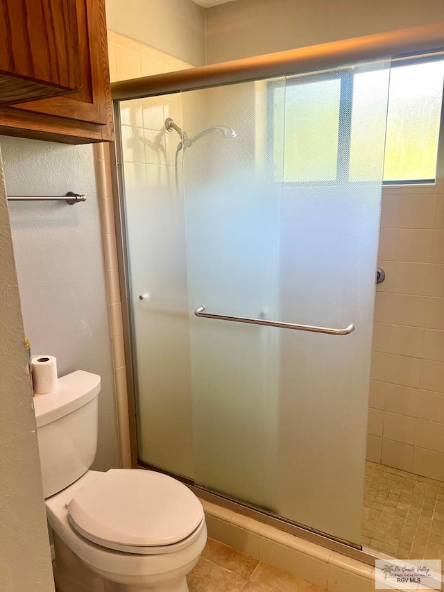 501 W Palm Valley Dr, Harlingen, TX 78552 - full bathroom featuring toilet, tile patterned floors, and a stall shower
