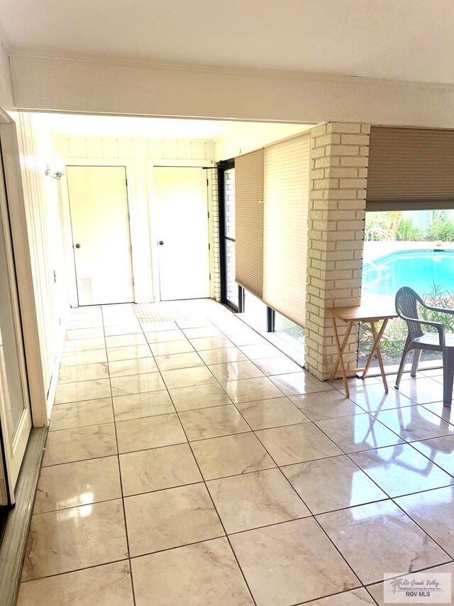 501 W Palm Valley Dr, Harlingen, TX 78552 - corridor featuring healthy amount of natural light and crown molding