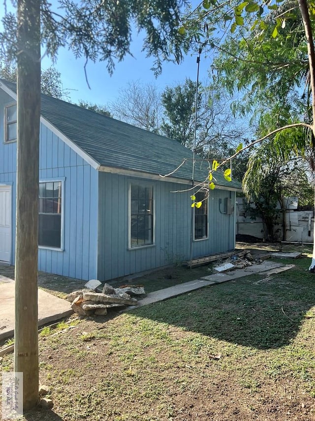 view of side of home with a lawn