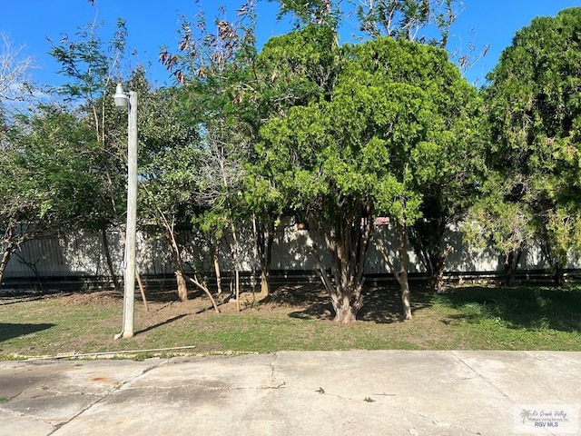 view of yard featuring fence and a patio