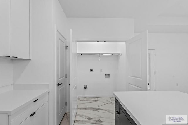 washroom featuring cabinets, hookup for a washing machine, and hookup for an electric dryer