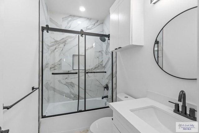 full bathroom with vanity, shower / bath combination with glass door, and toilet