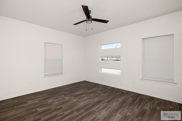 spare room featuring ceiling fan and dark hardwood / wood-style flooring