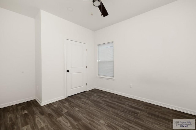 unfurnished room with ceiling fan and dark wood-type flooring