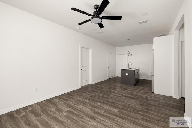 interior space with dark hardwood / wood-style floors, ceiling fan, and sink