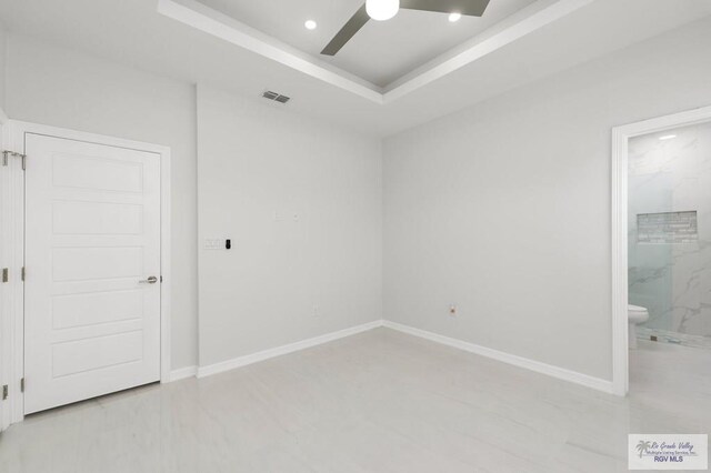 kitchen featuring a breakfast bar, white cabinets, wine cooler, appliances with stainless steel finishes, and a tray ceiling