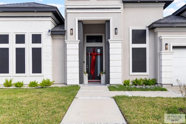 doorway to property with a lawn