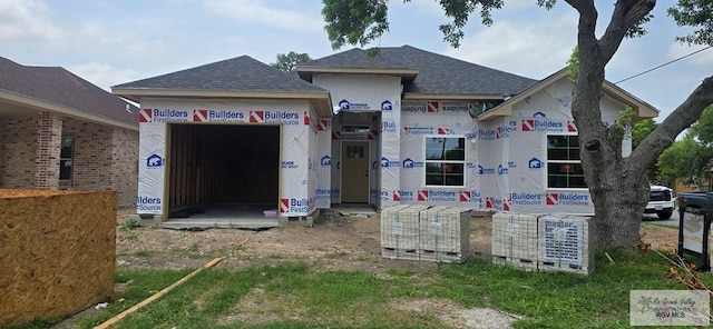 property under construction featuring a shingled roof
